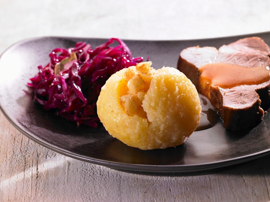Roast pork with a dumpling and red cabbage