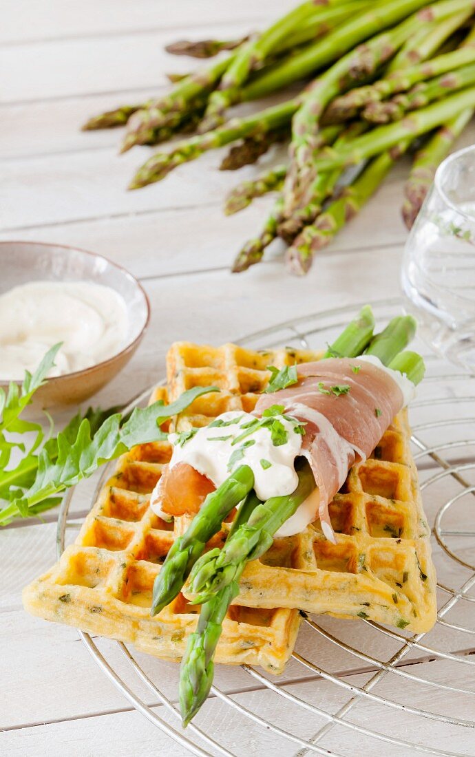 Herb waffles with asparagus and ham rolls and rocket