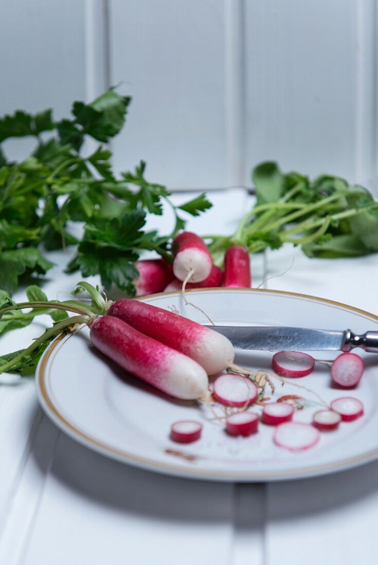 Radishes, partially sliced, on a plate