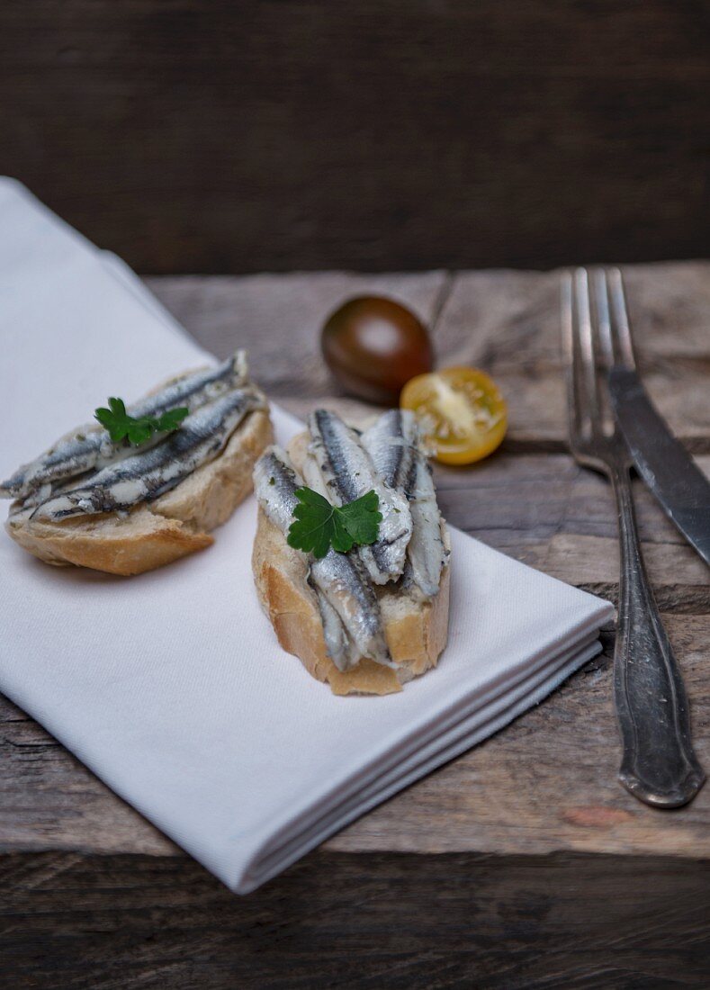 Sardines on bread, cherry tomatoes and parsley