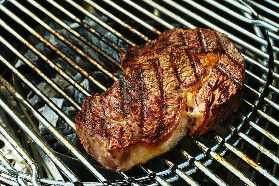 Rib-eye steak on a charcoal grill