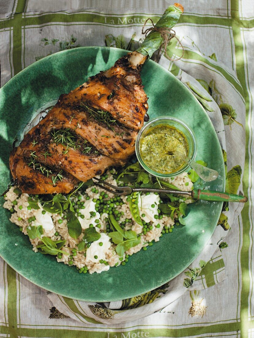 A leg of lamb with peas and risotto