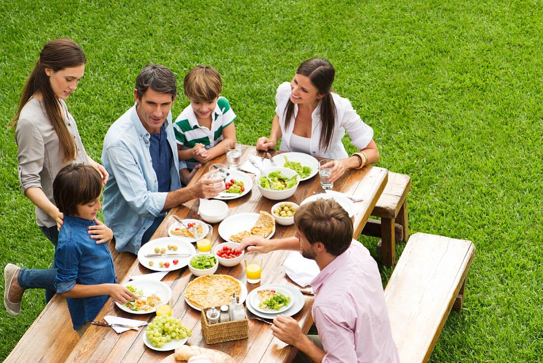 A family eating lunch in a garden