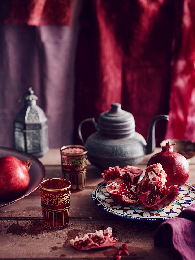Pomegranate, tea pot and coloured glasses