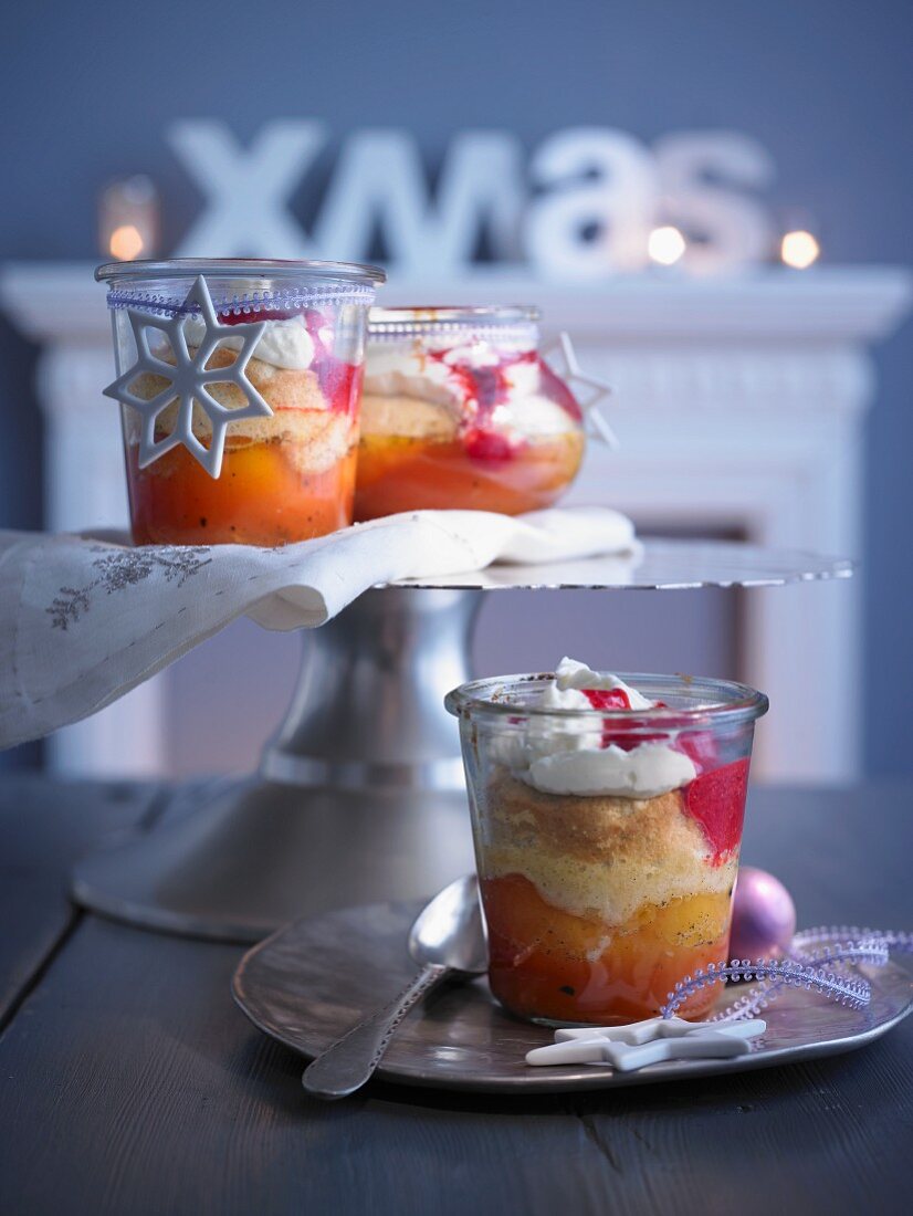 Vanilla peaches in jars with an almond sponge topping, raspberry sauce and whipped cream (Christmas)