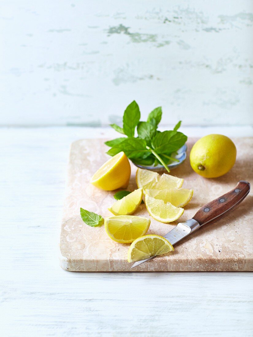 Fresh mint and lemon, whole and cut into wedges