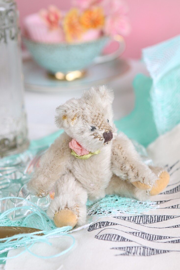 Old-fashioned teddy bear sitting on fabric