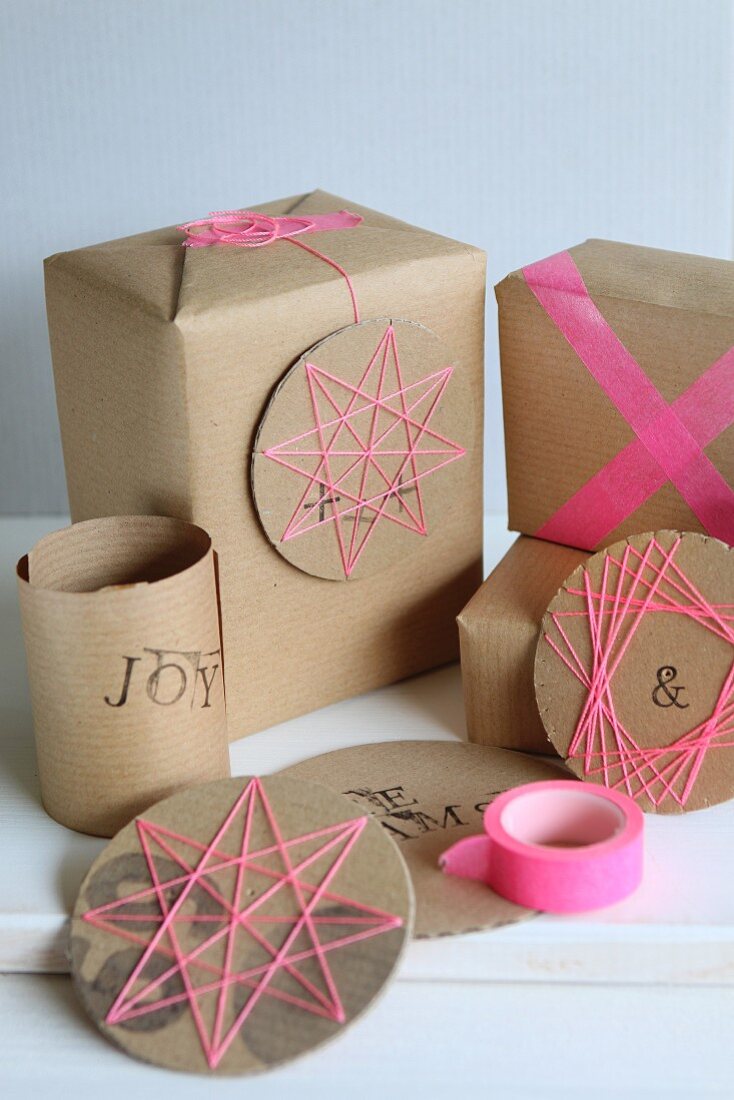 Hand-crafted, circular cardboard decorations with patterns of thread