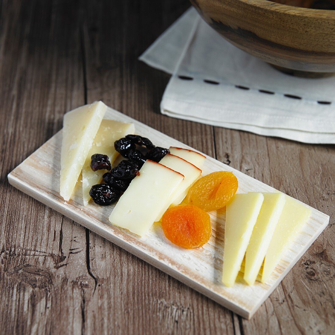 A cheese platter with dried fruits