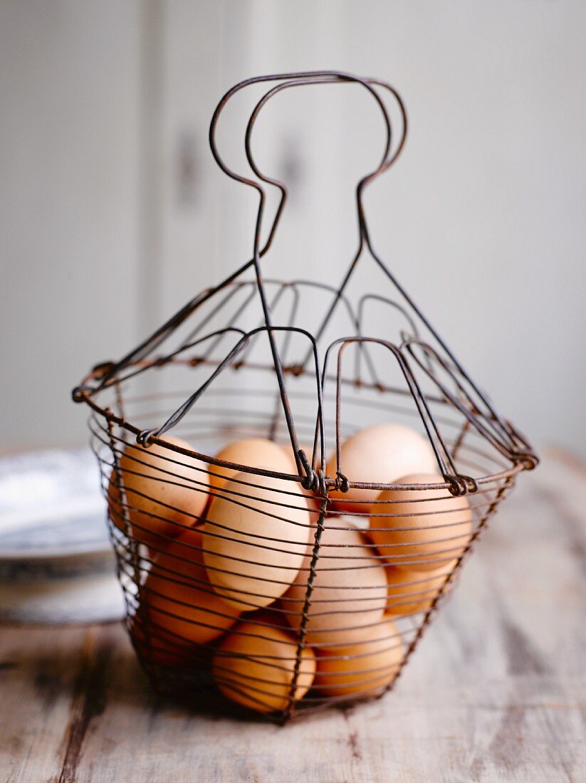 Brown hen's eggs in a wire basket