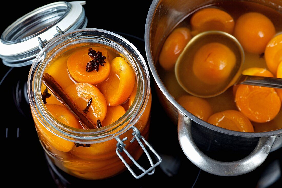 Apricot compote in a jar and in a pot