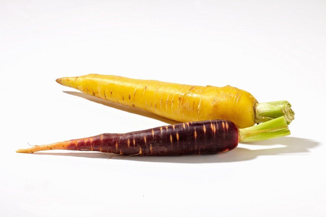 A purple carrots and a yellow carrot