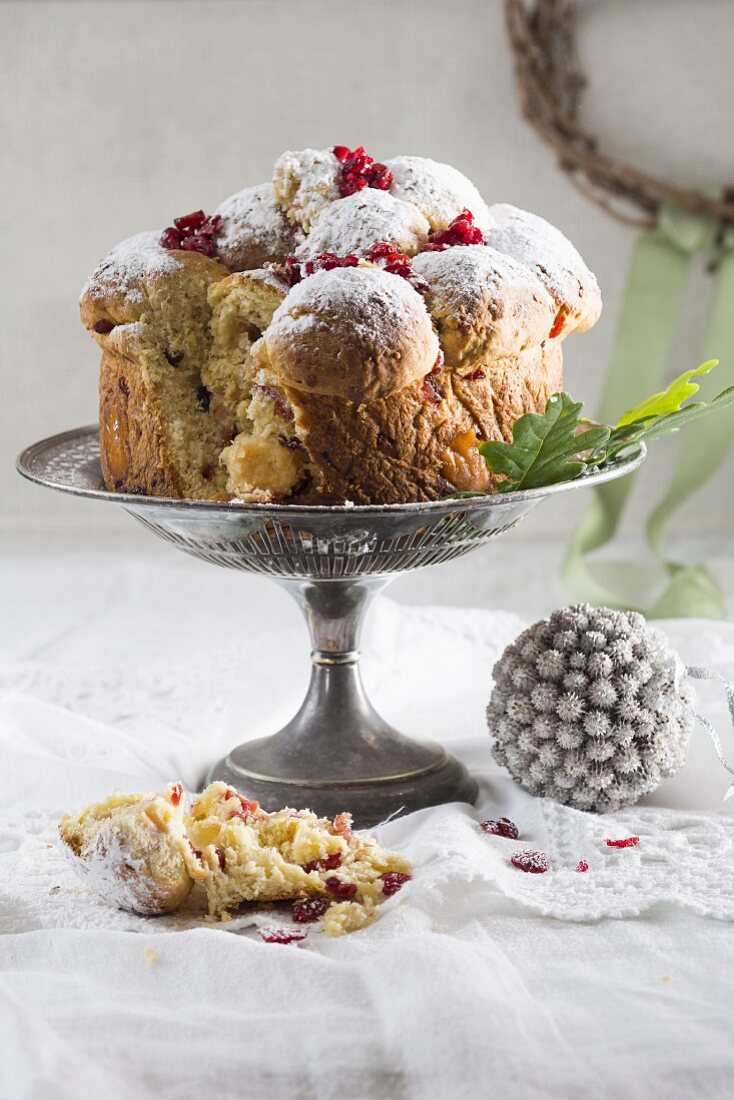 Stollen with cranberries on a cake stand