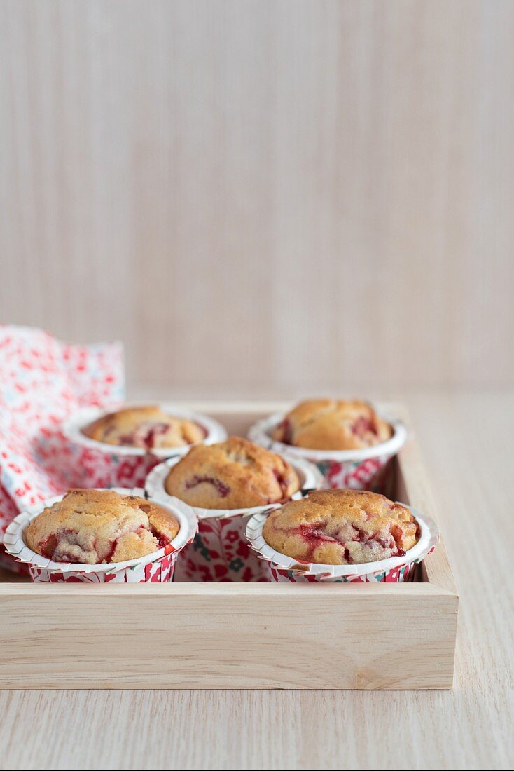 Strawberry muffins on a wooden tray