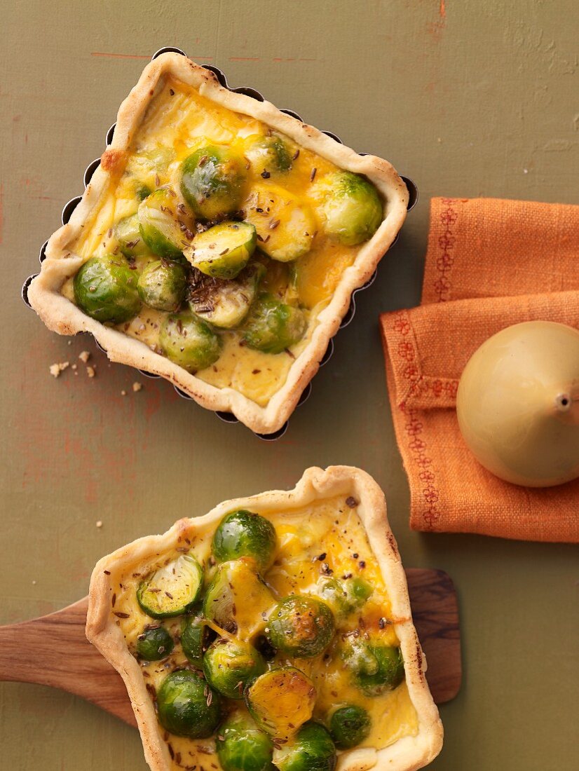 Brussels sprouts quiches with a mustard and Cheddar cheese sauce