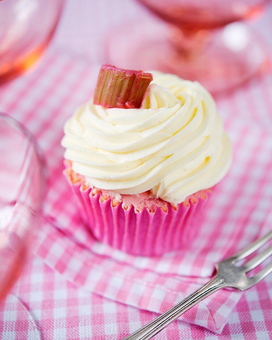 A rhubarb cupcake with vanilla cream