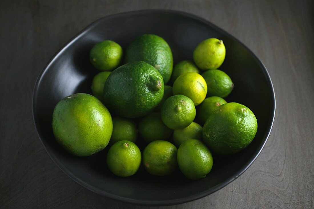 Limes in a black bowl