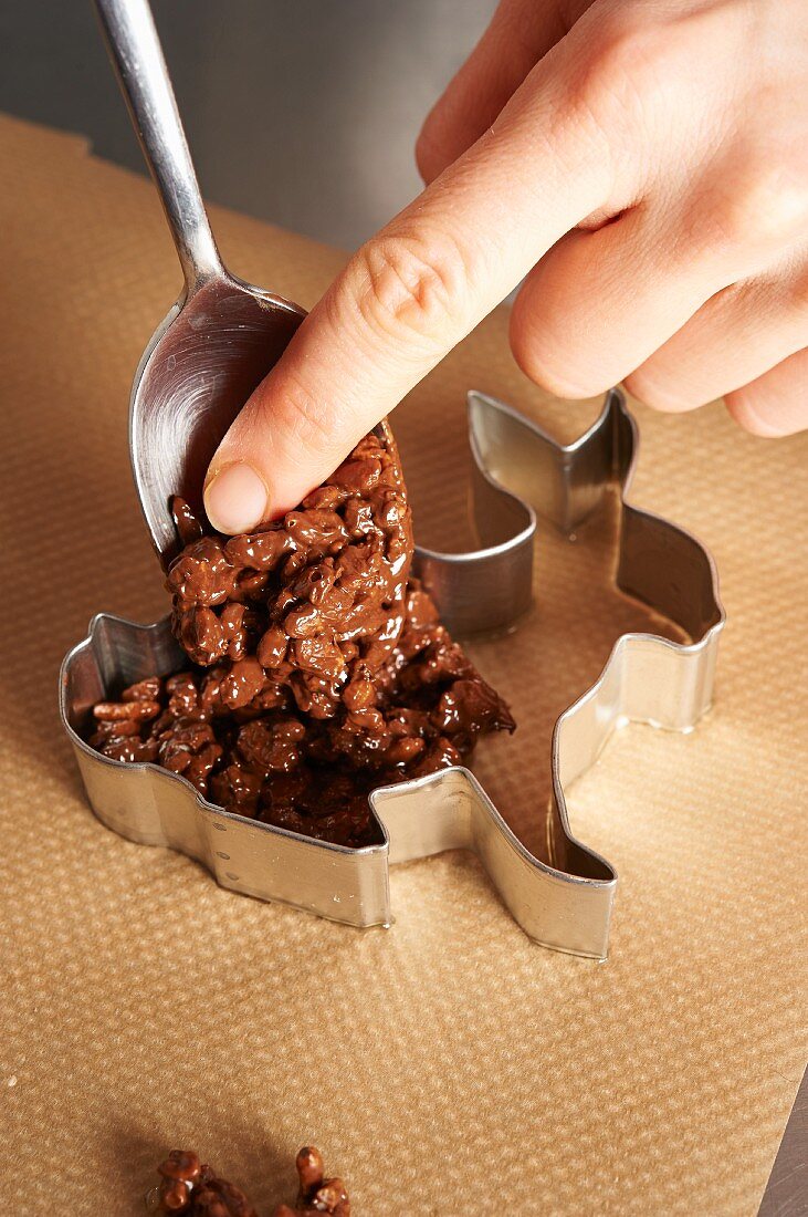 A crispy bunny being made: chocolate rice crispy mixture being placed in a mould