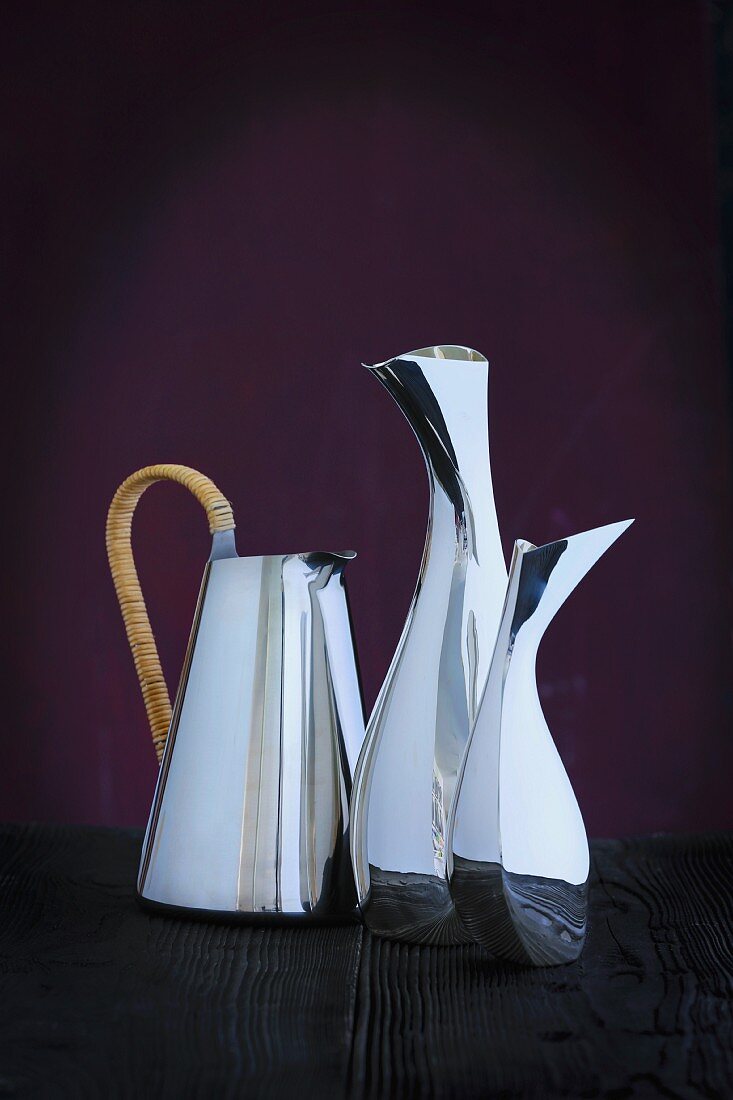 Curved, silver-plated designer jugs