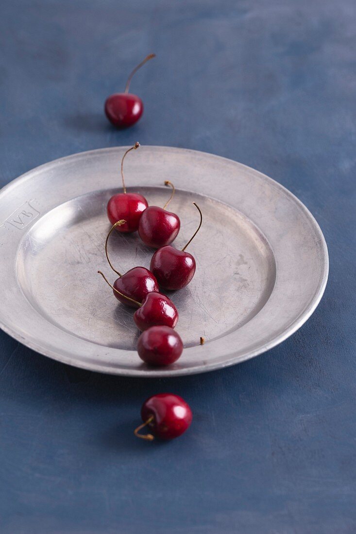 Sweet cherries in a pewter plate
