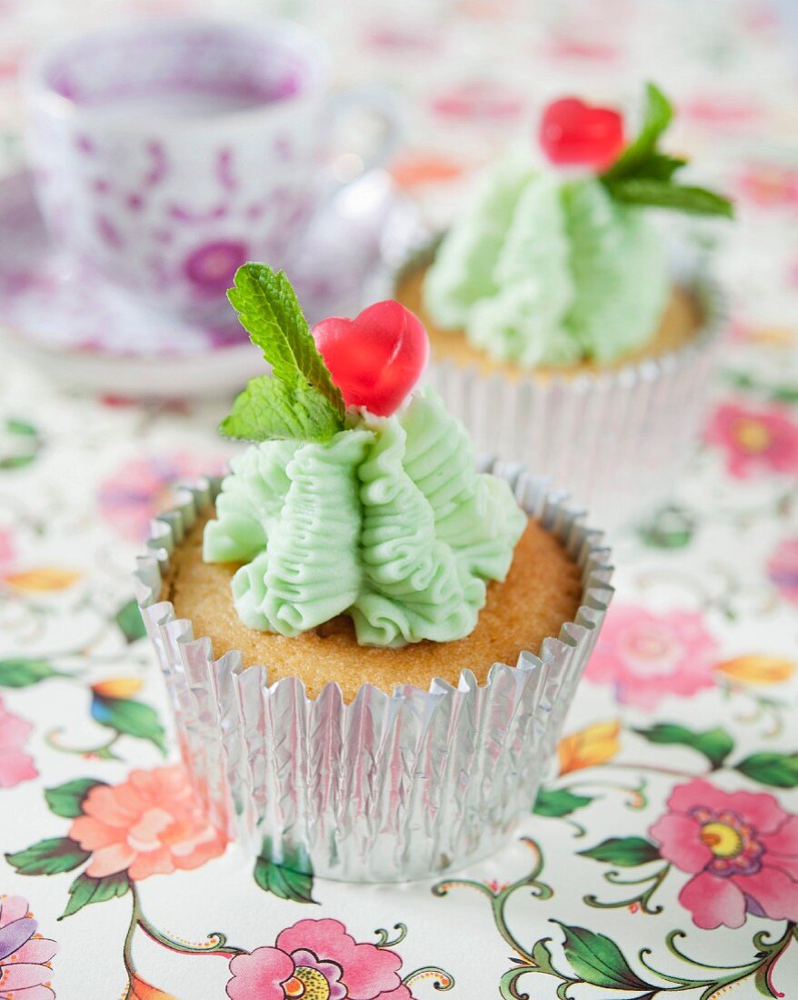 Cupcakes with mint icing and heart-shaped sweets