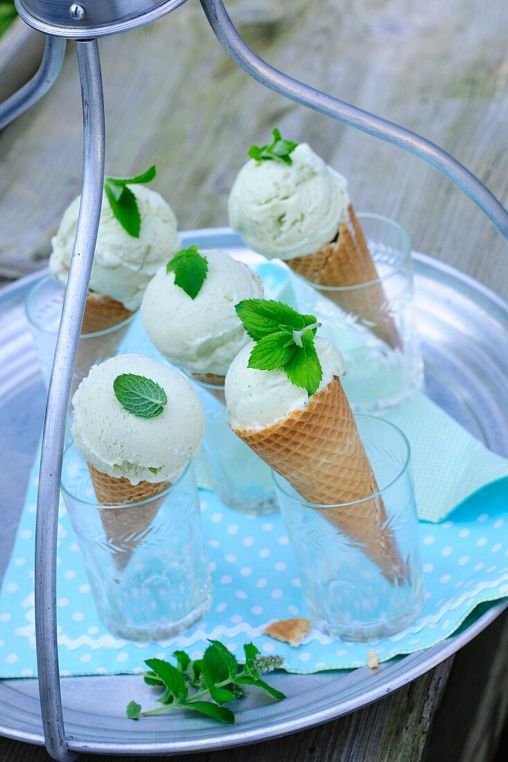 Ice cream cones in glasses on a garden table