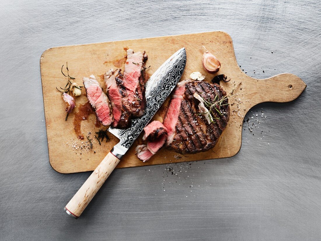 Wagyu rribeye steak with rosemary, roasted and sliced