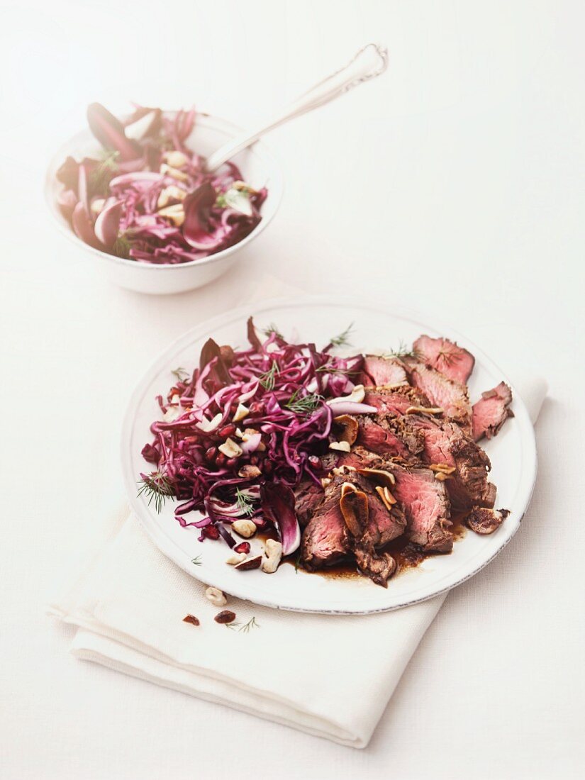 Marinated beef with a red cabbage salad, cashew nuts and dill