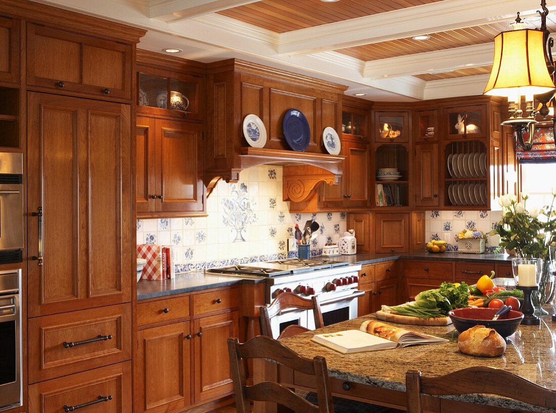 Kitchen-dining room with wooden fronts and wall units in cosy, country-house interior