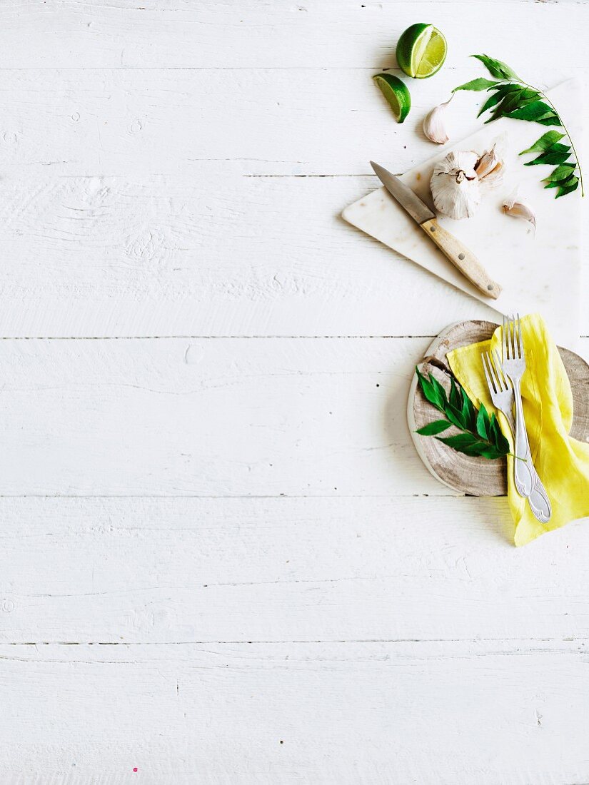 White wooden table with ingredients and kitchen utensils