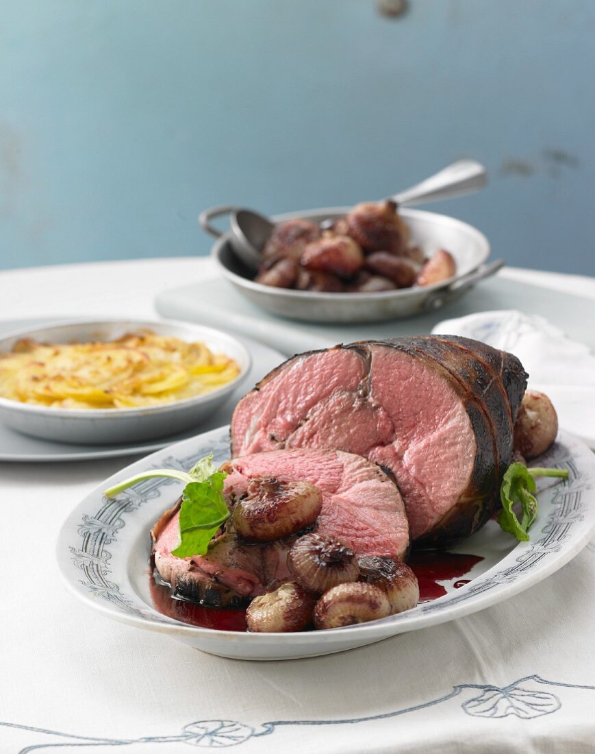 Sauerbraten (marinated pot roast) from milk-fed lamb with caramelised onions and potato gratin