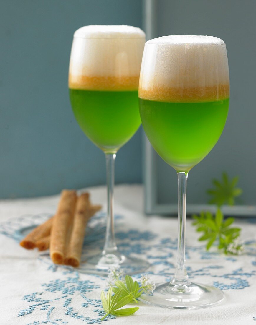 Glasses of woodruff jelly with melon soup and cremant