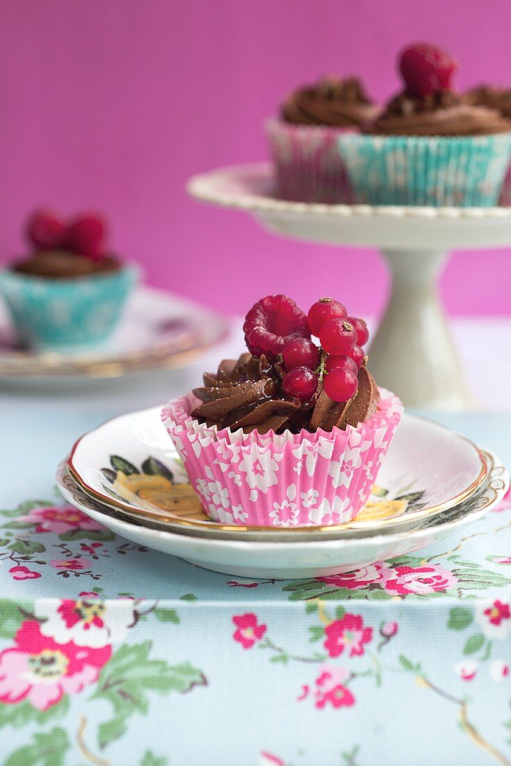 Chocolate cupcakes with chocolate frosting and fresh berries