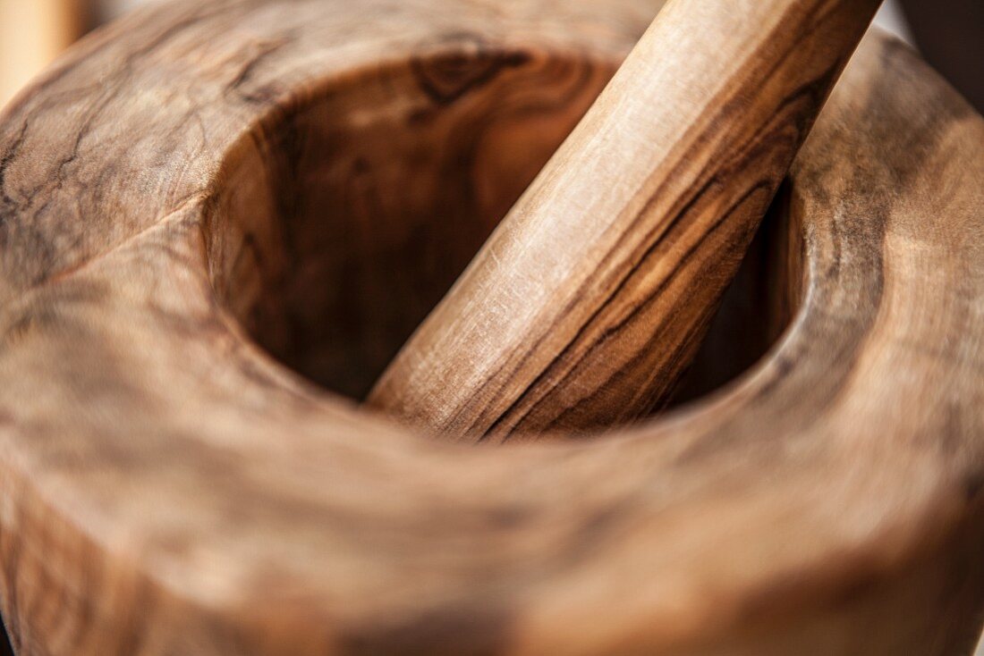 A wooden mortar and pestle (close-up)