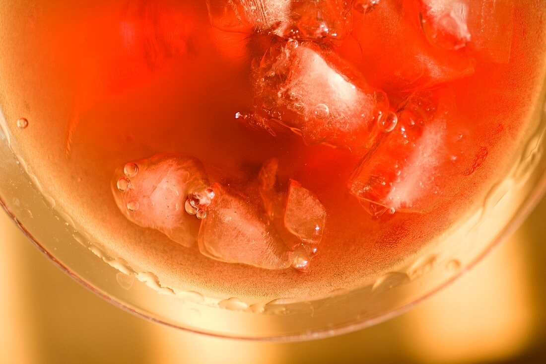 A cranberry cocktail with ice cubes (close-up)