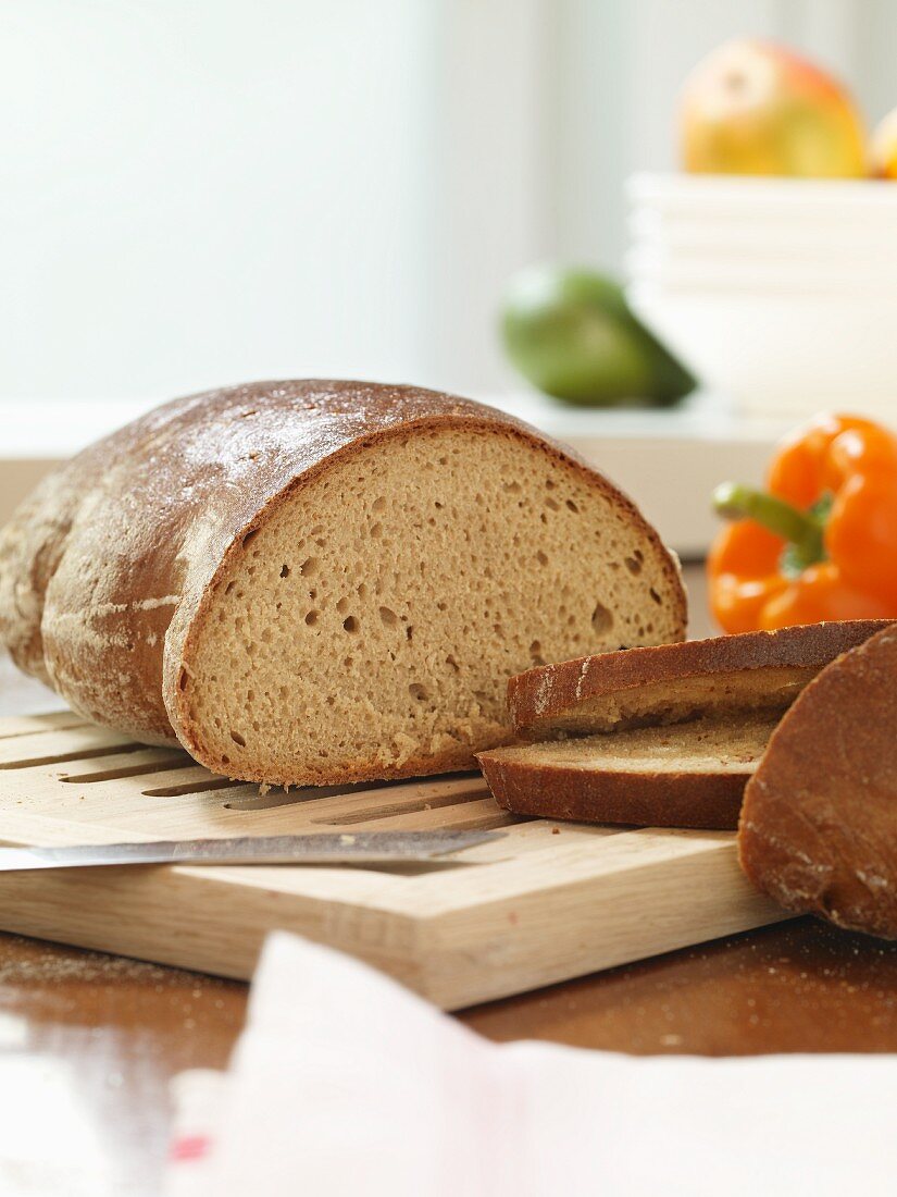 A sliced loaf of bread and a pepper