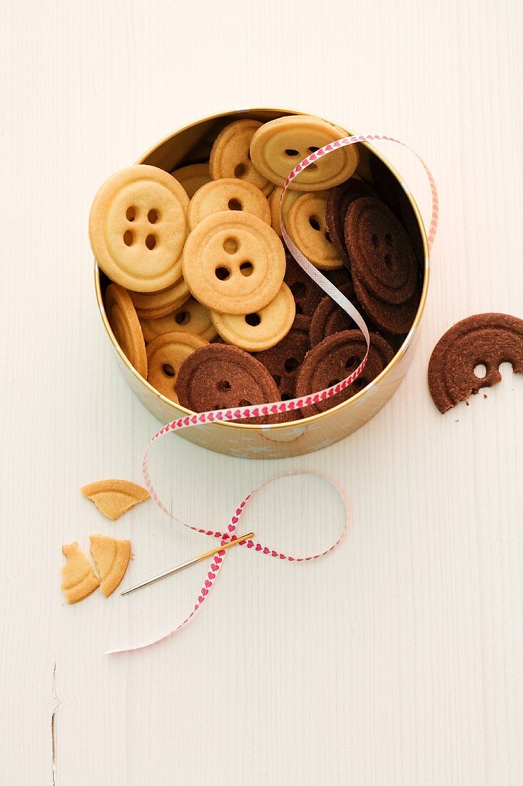 Light and dark button biscuits in a biscuit tin