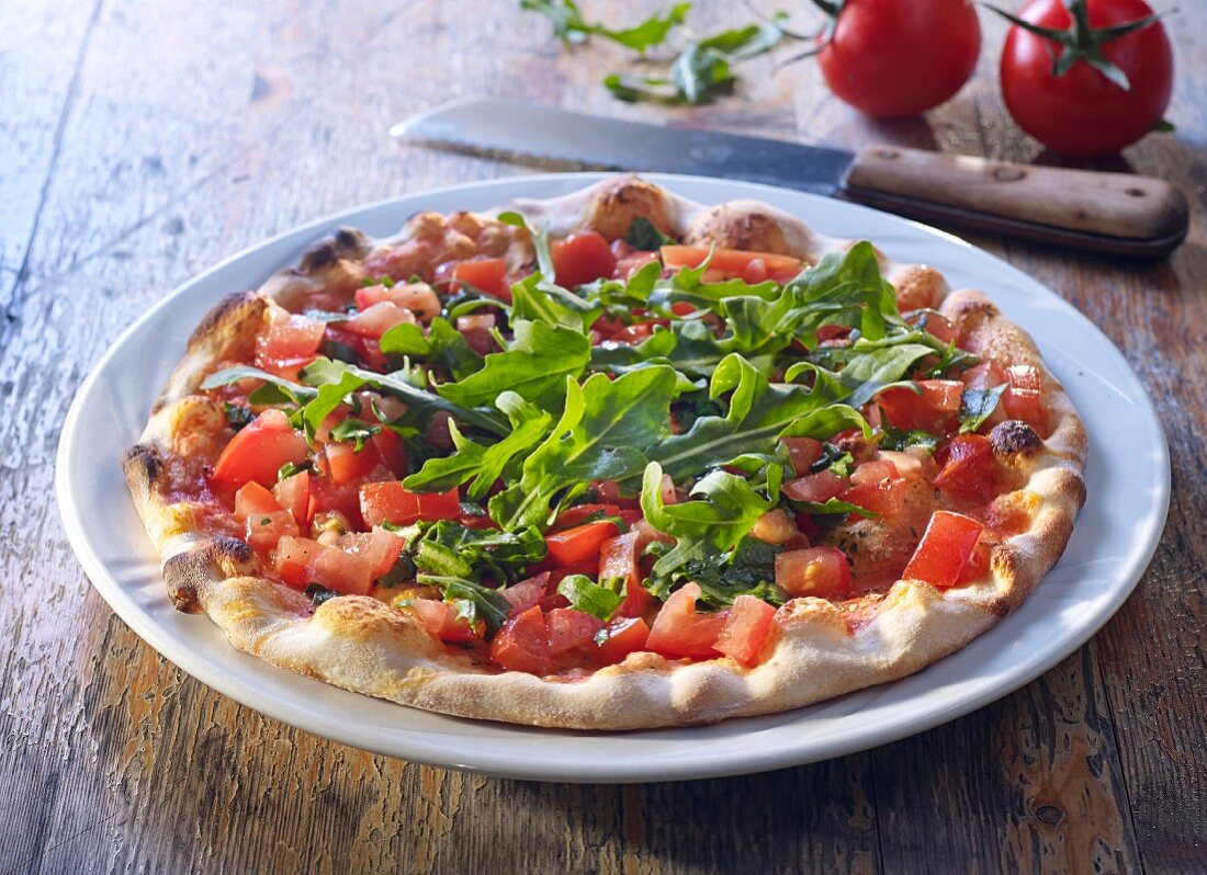 Pizza bread with fresh tomatoes and rocket