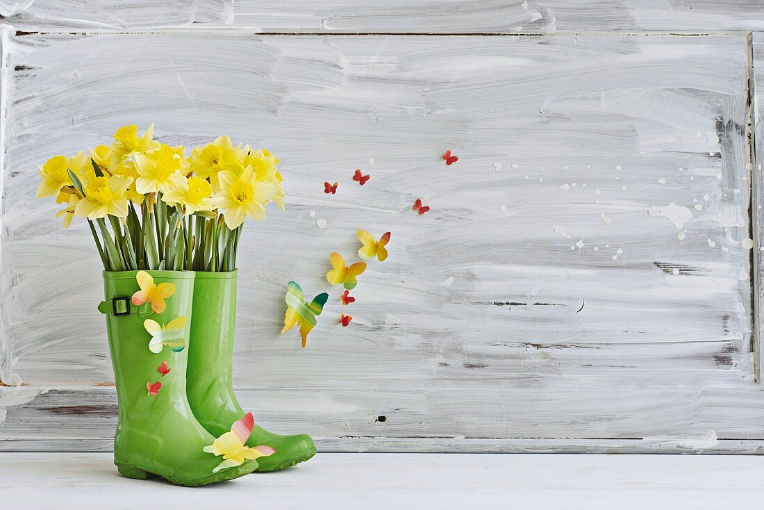 Wellington boots repurposed as spring vase & decorated with paper butterflies