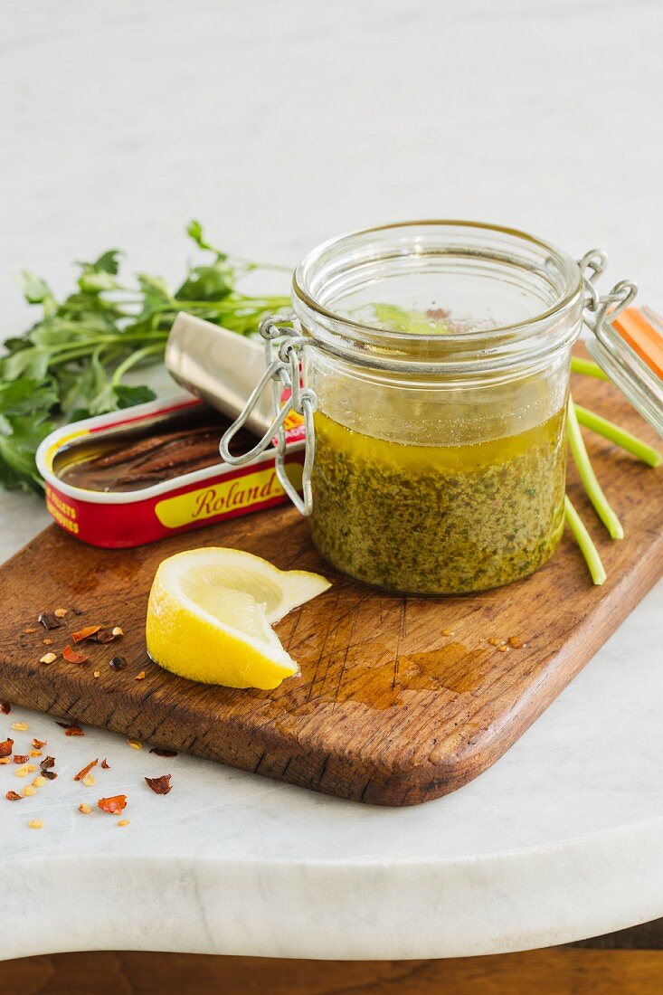 Anchovy sauce with lemons and capers in a flip-top jar