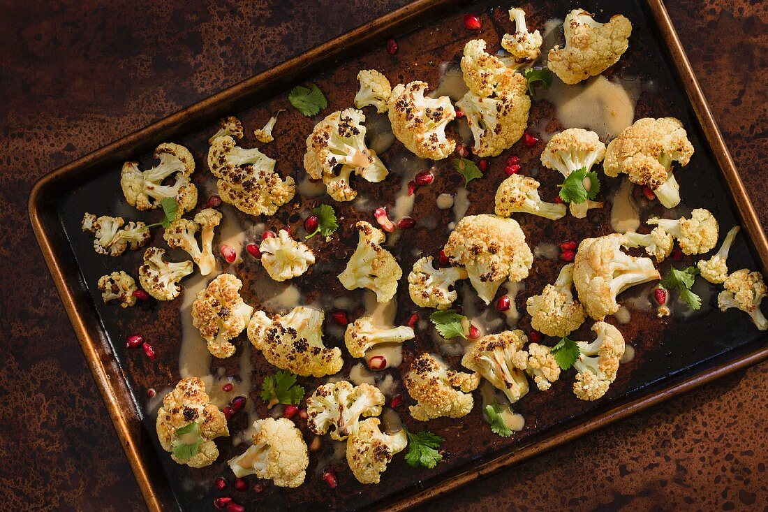 Oven-baked cauliflower with pineapple seeds and tahini