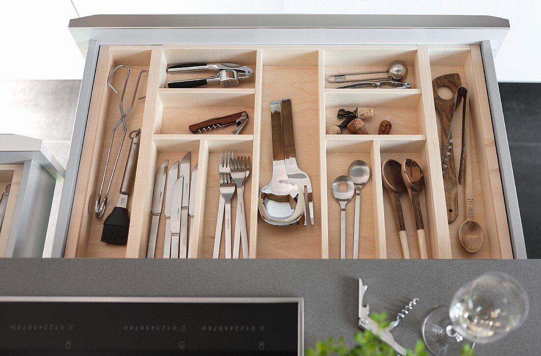 An opened cutlery drawer