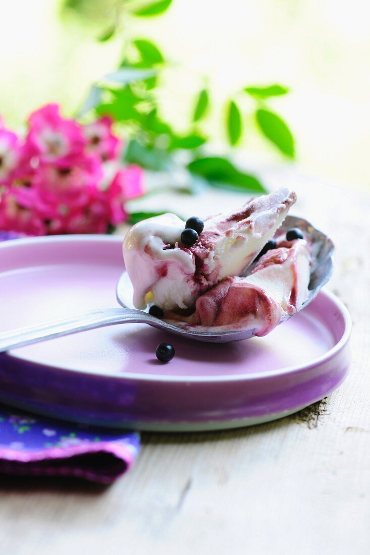 Elderberry and yoghurt ice cream on a spoon
