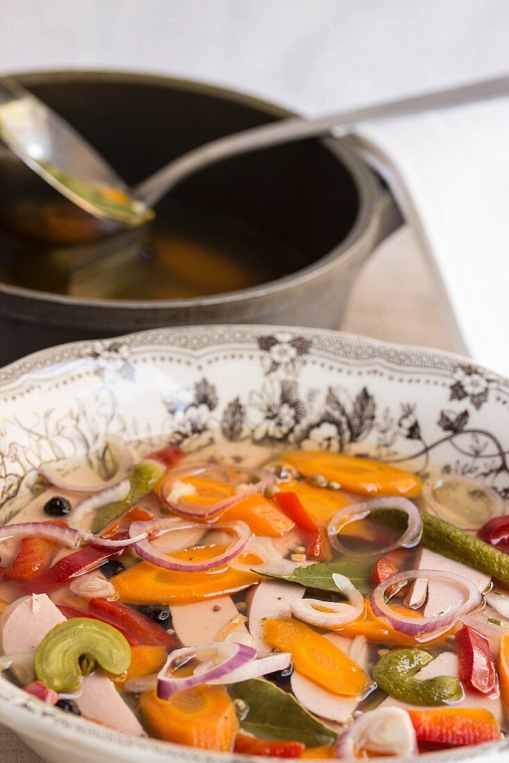 Aspic with sausage, carrots, gherkins, peppers, onions, pepper and bay leaves