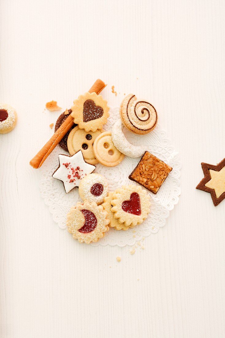 Various Christmas biscuits with cinnamon sticks (seen from above)