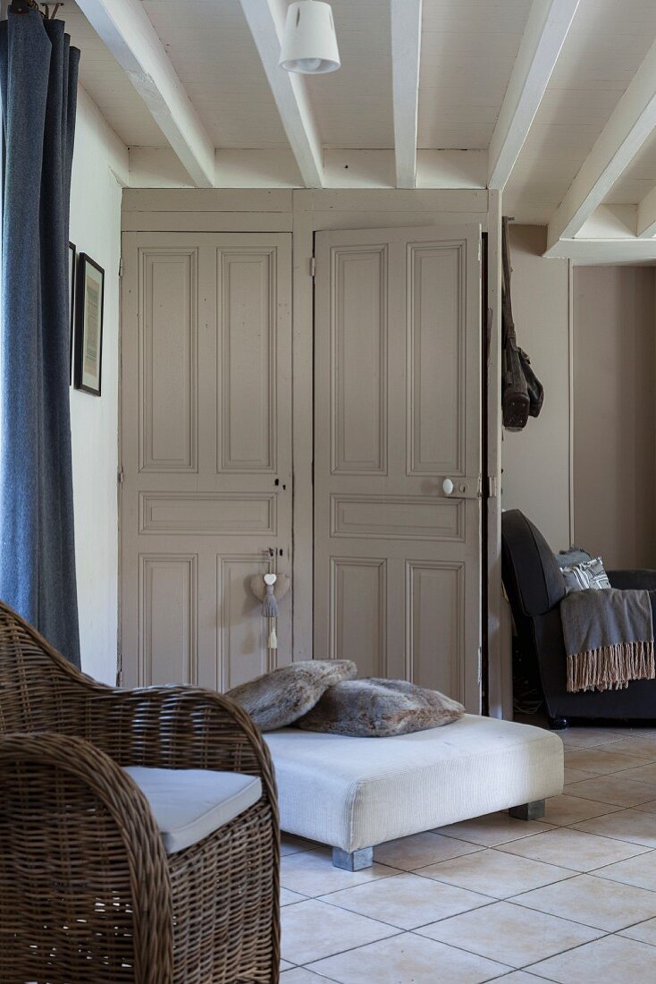 Two old panelled doors in living room with exposed ceiling beams