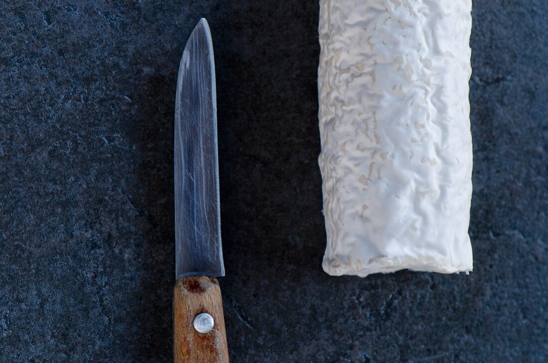 French goat's cheese with a knife (seen from above)