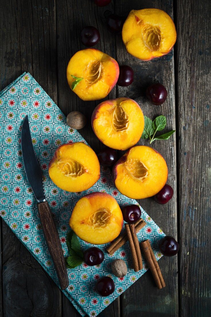 An arrangement of nectarines, cherries and spices