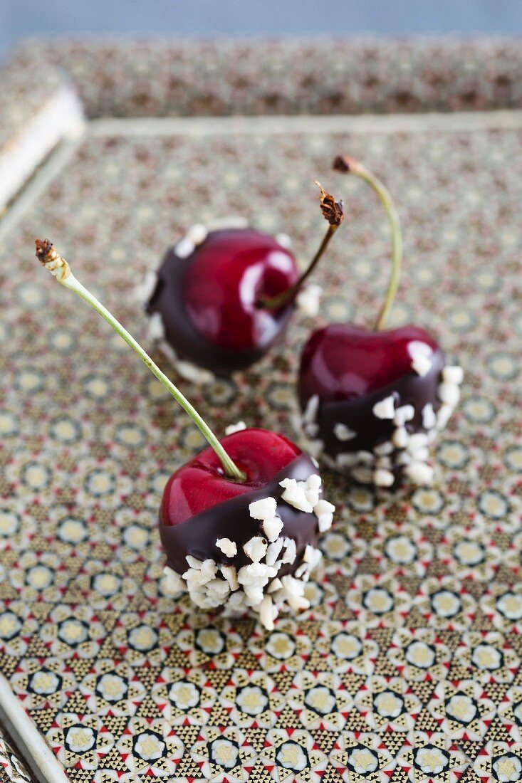 Chocolate-coated cherries with chopped almonds