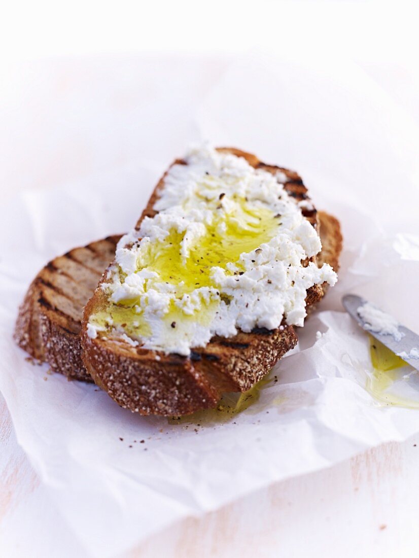 Grilled bread topped with ricotta and olive oil